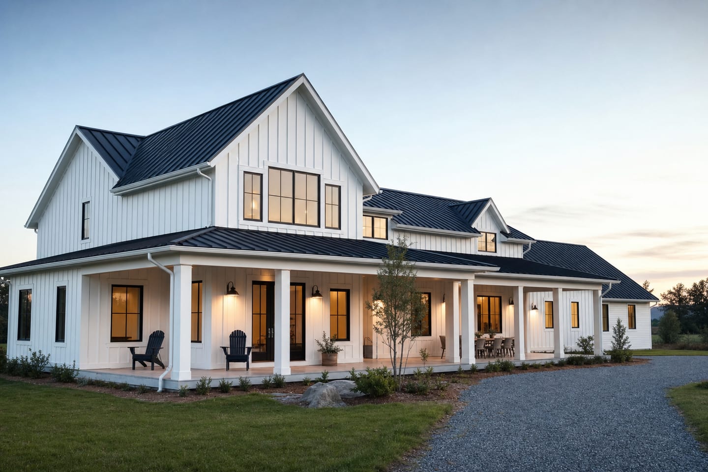 A modern farmhouse-style home with a metal roof and a wide porch on an open lot
