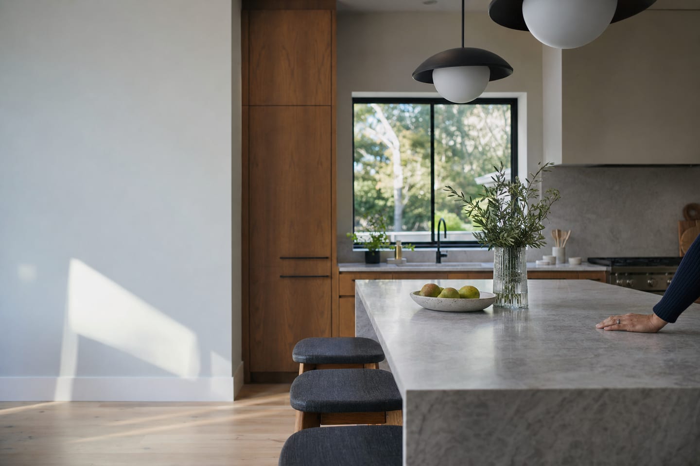A freshly renovated kitchen with an island and pendant lights in a family home